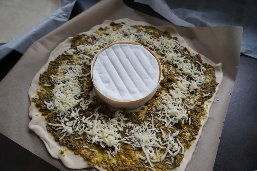 Der Pizzateig wird belegt
